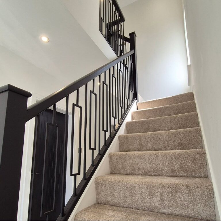Modern staircase renovation with black metal spindles and modern handrails