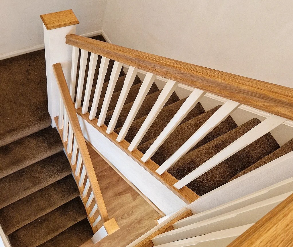 Oak and white staircase renovation with oak handrail and white spindles